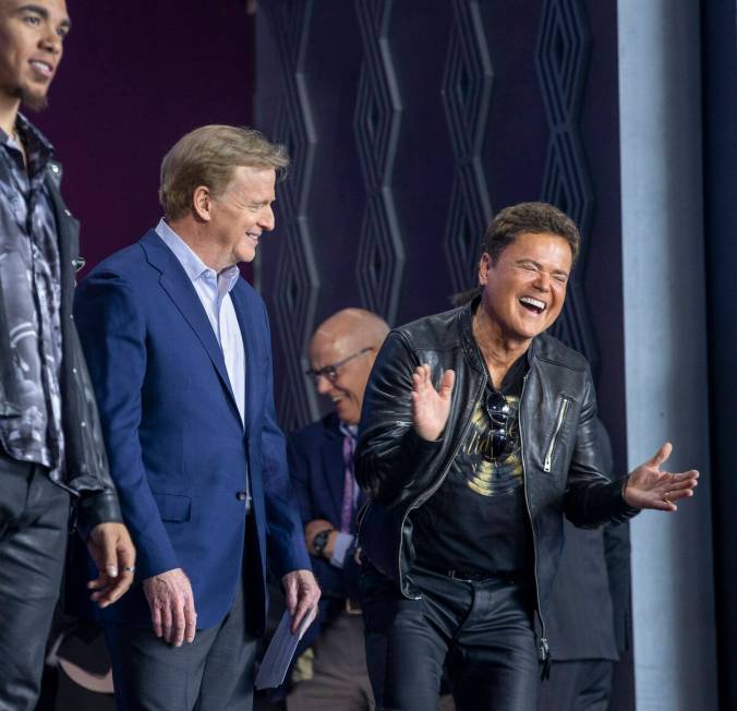 Commissioner of the National Football League Roger Goodell shares a laugh with Donny Osmond on ...