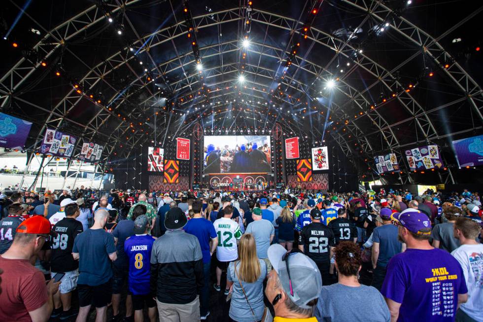 Fans watch as the fourth round of the NFL draft kicks off on the third day of the draft Saturda ...