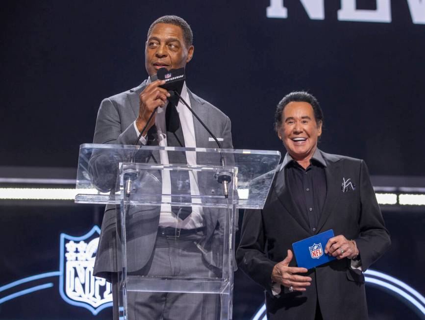 Marcus Allen and Wayne Newton announce 90th player selection at the Draft Theater during the se ...