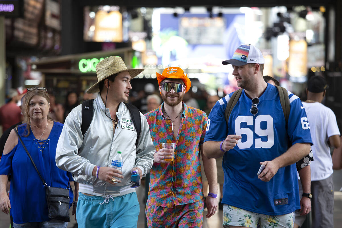 Fans check out Fremont Street Experience as the NFL football draft is in town Friday, April 29, ...