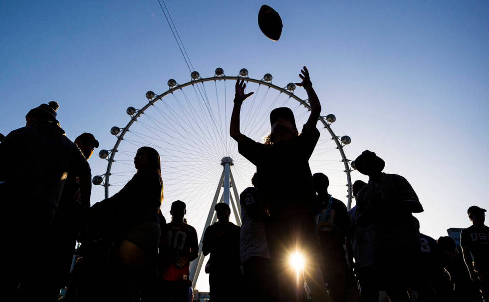 Fans socialize outside the NFL Draft Stage during day two of the NFL draft on Friday, April 29, ...