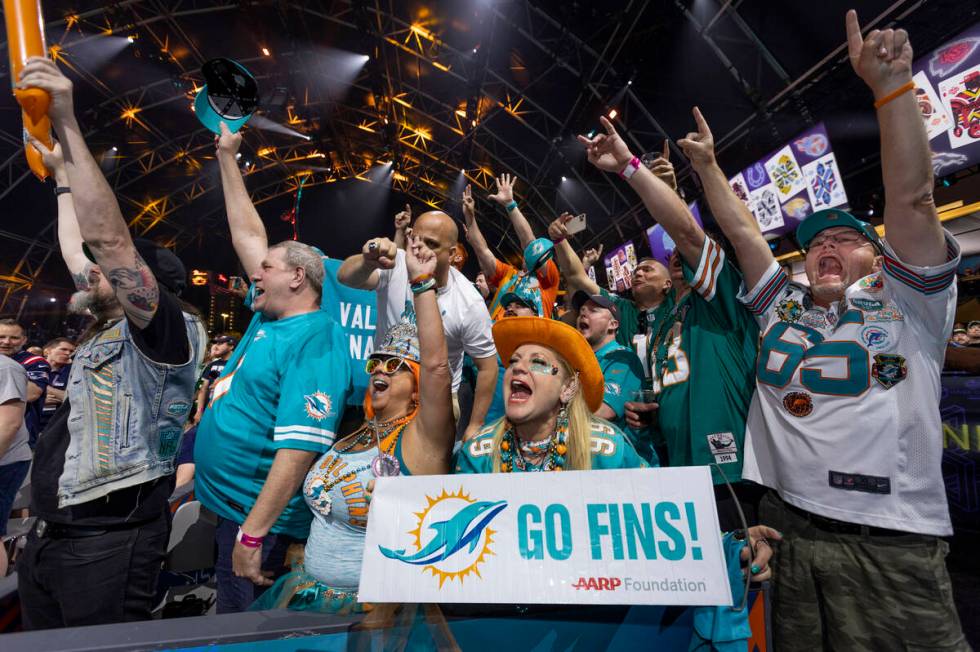 Miami Dolphins fans cheer as a selection for the team is announced at the Draft Theater during ...