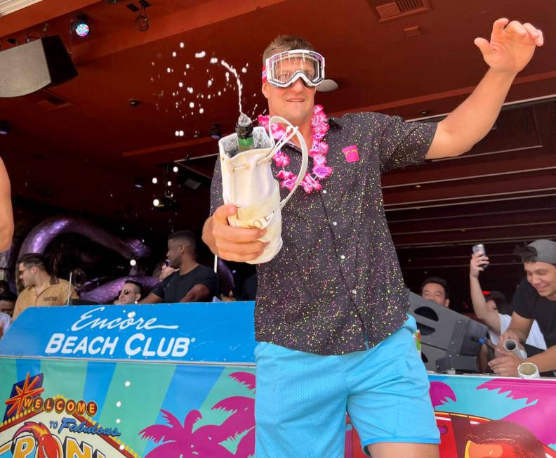 Rob Gronkowski sprays sparkling wine on the crowd during Gronk Beach party at Encore Beach Club ...
