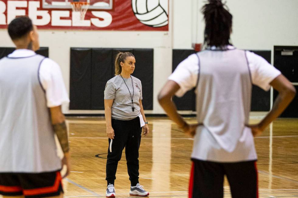 Las Vegas Aces guard Kierstan Bell, left, and forward Mya Hollingshed listen to head coach Beck ...