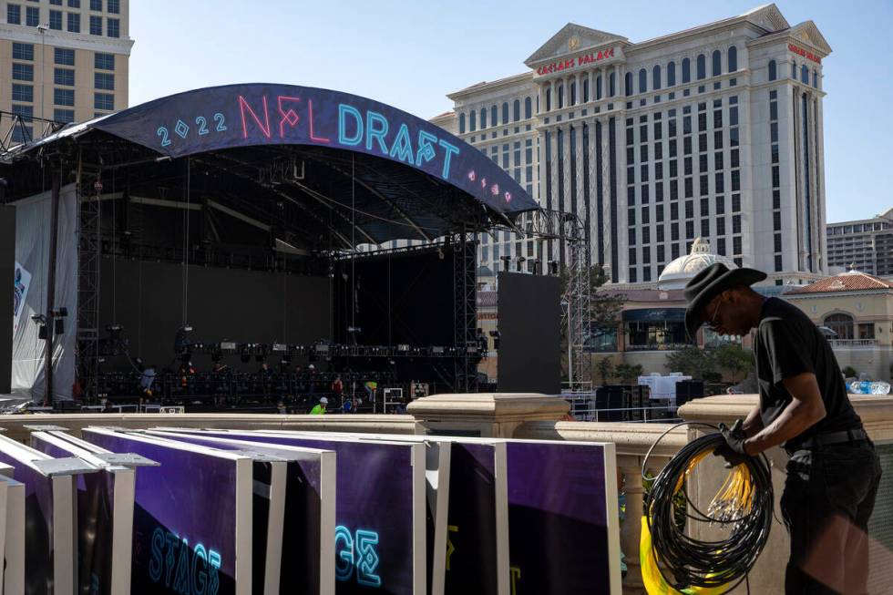 NFL Network crew members dismantle the NFL draft stage in the Bellagio Fountain on Saturday, Ap ...
