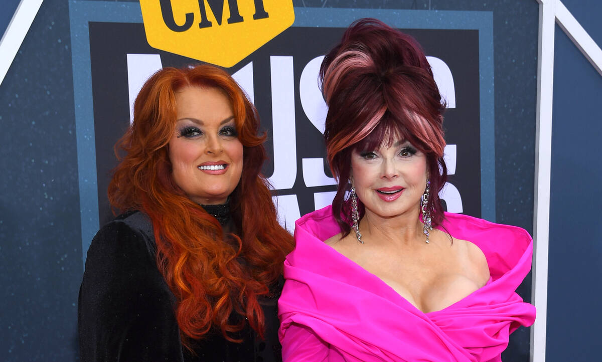 FILE - Wynonna Judd, left, and Naomi Judd arrive at the CMT Music Awards on Monday, April 11, 2 ...
