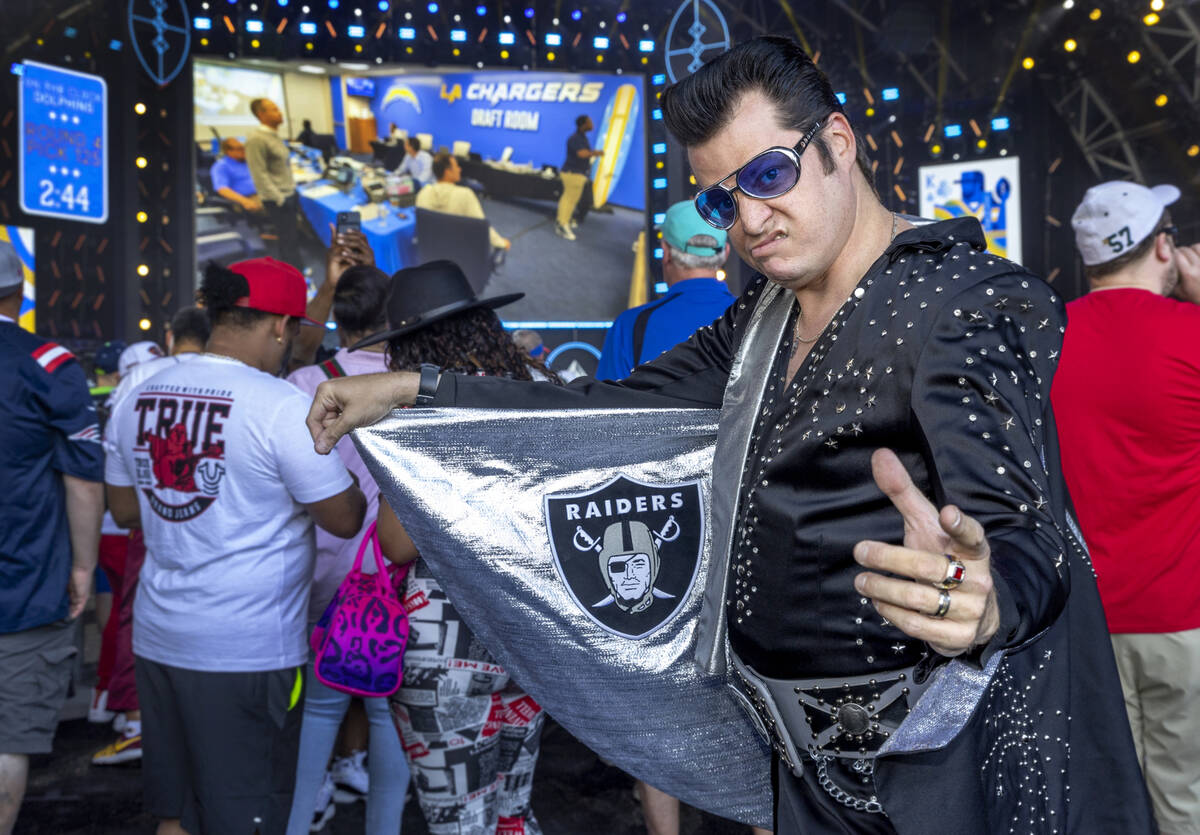 Elvis in Raiders garb hangs out in the Draft Theater during the third day selections for the 20 ...