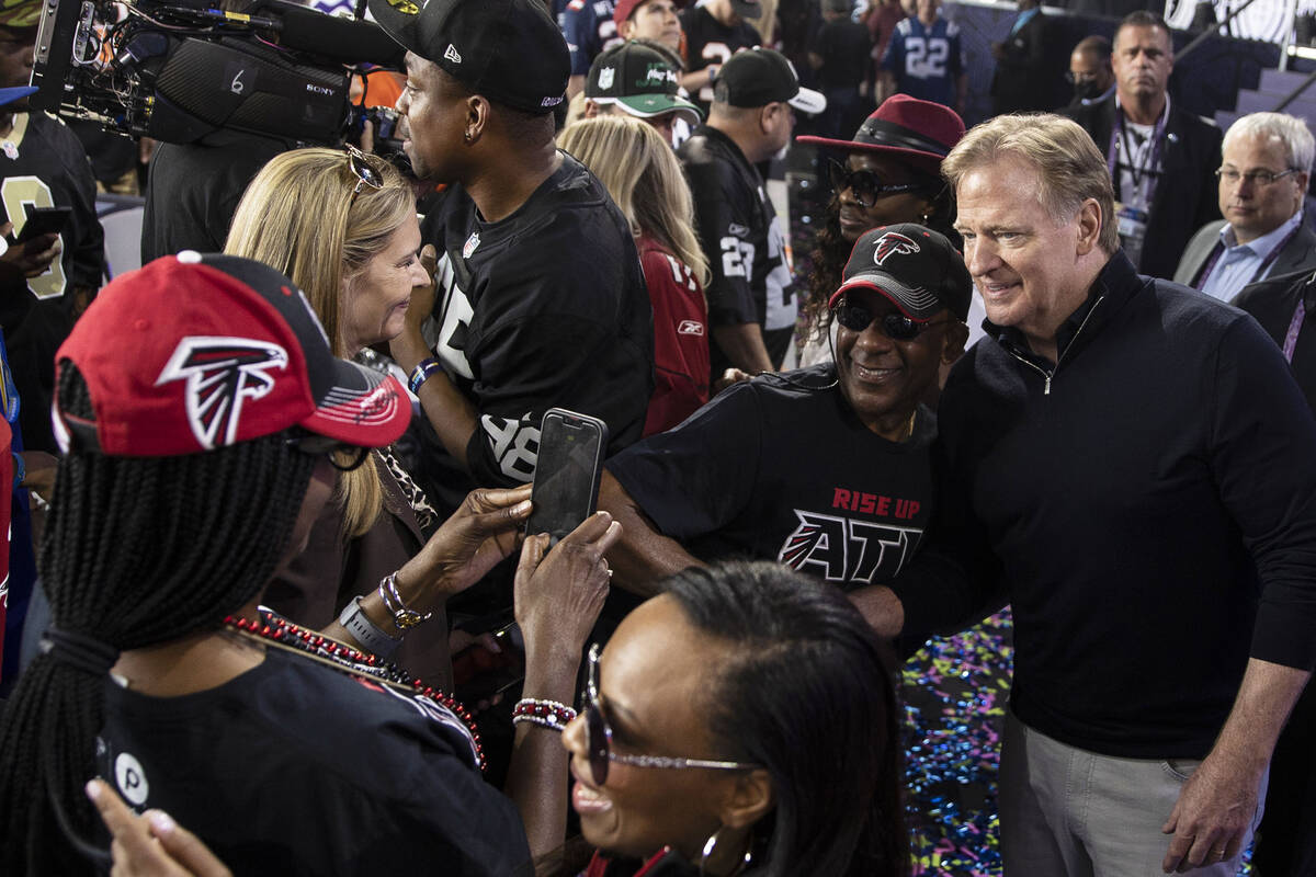 NFL commissioner Roger Goodell, right, socializes with fans during day three of the NFL draft o ...