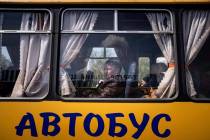 Women wait in a bus at a center for displaced people in Zaporizhzhia, Ukraine, Monday, May 2, 2 ...