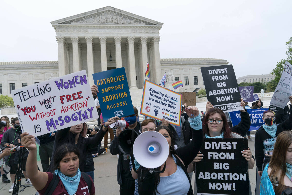Demonstrators protest outside of the U.S. Supreme Court Tuesday, May 3, 2022 in Washington. A d ...