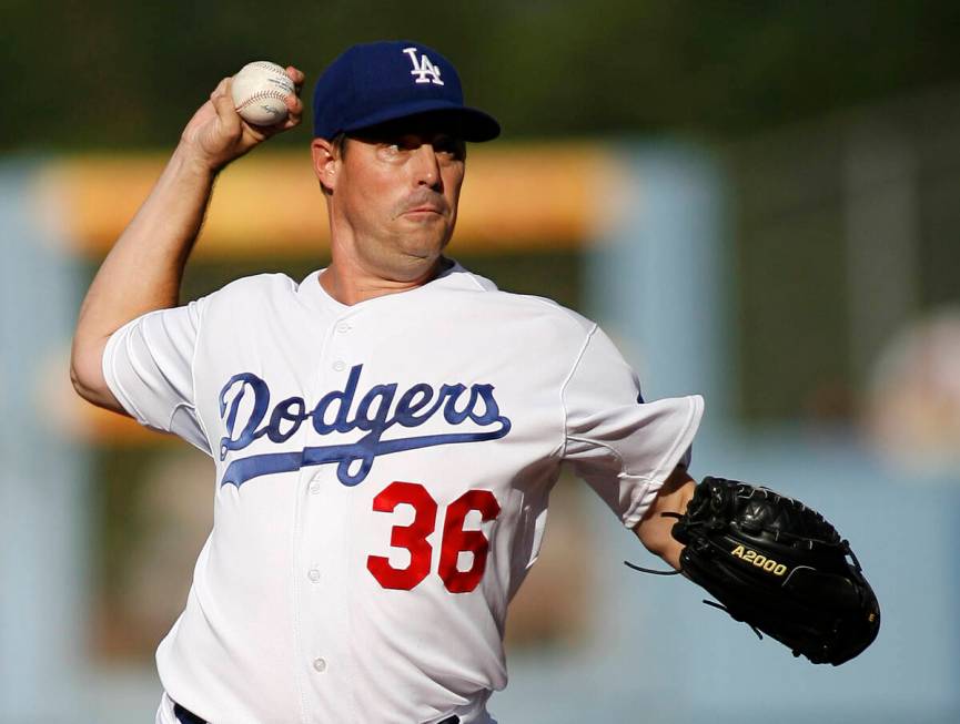 Los Angeles Dodgers' Greg Maddux pitches in the first inning of an MLB baseball game against th ...