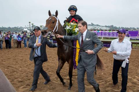 Ron Winchell, right, and assistant trainer Scott Blasi lead Echo Zulu and jockey Joel Rosario t ...