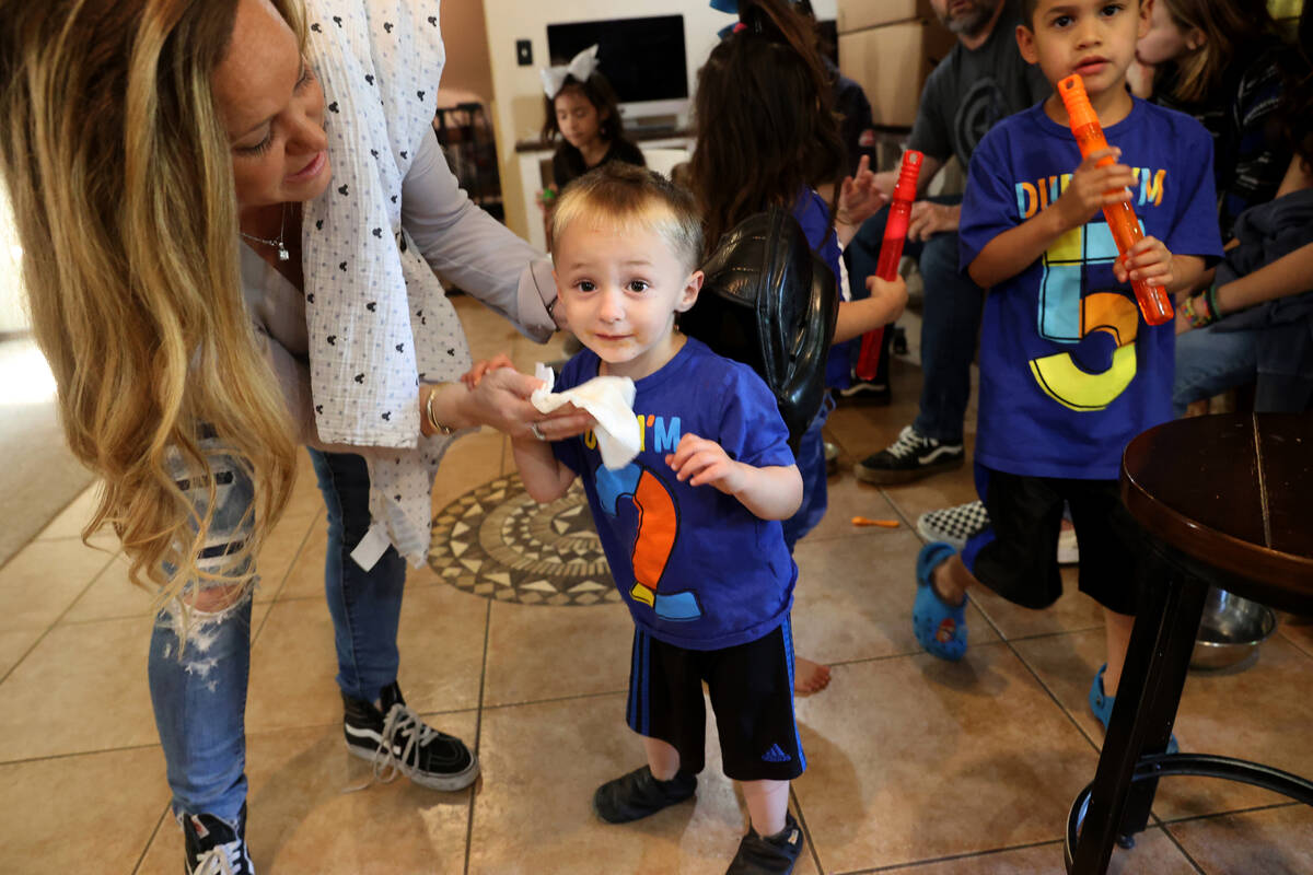 Aimee Hairr wipes the face of Timothy, 2, at their Henderson home Friday, April 22, 2022. Hairr ...