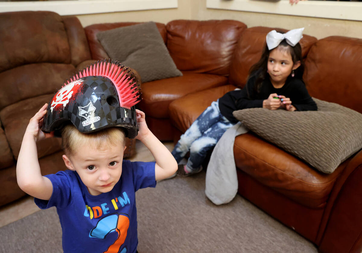 Siblings Timothy, 2, left, and Genesis Marie Hairr, 7, play at their Henderson home Friday, Apr ...