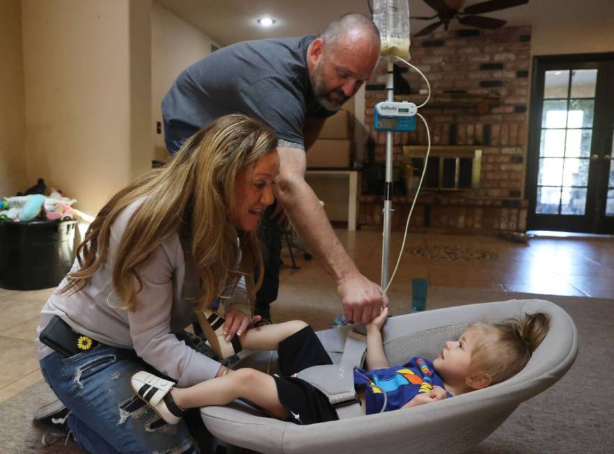 Aimee and Heath Hairr feed Aksel, 1, at their Henderson home Friday, April 22, 2022. The couple ...