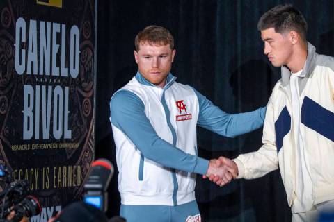 Canelo Alvarez, left, shakes hand with Dmitry Bivol during boxing Grand Arrivals at the MGM Gra ...