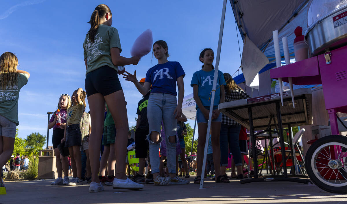 Kids wait in line for cotton candy as part of a celebration of life for Austen Russell, 9, who ...