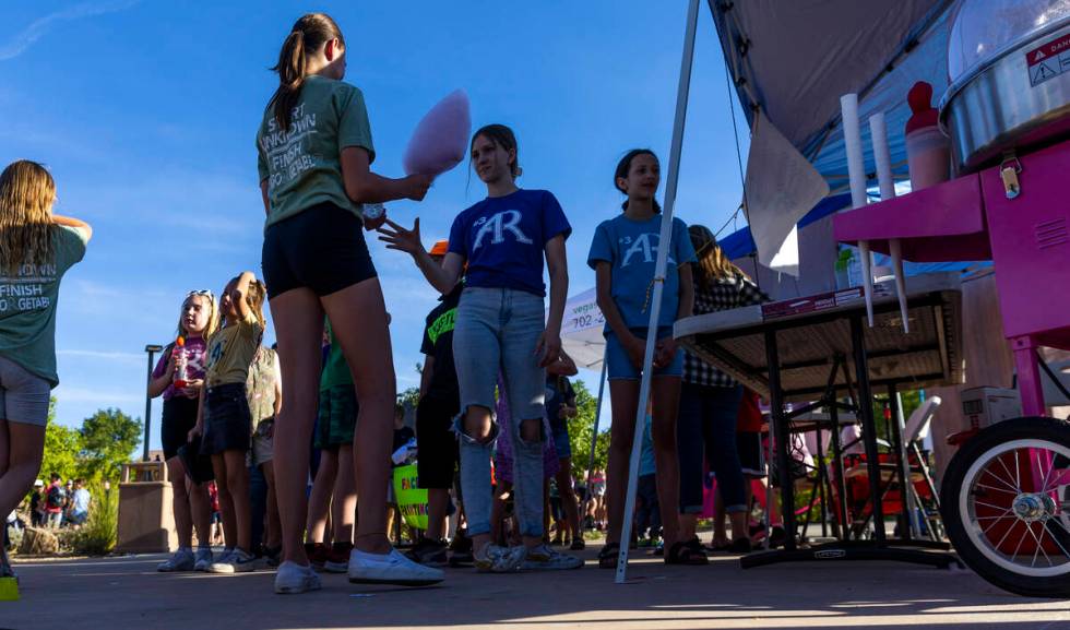 Kids wait in line for cotton candy as part of a celebration of life for Austen Russell, 9, who ...