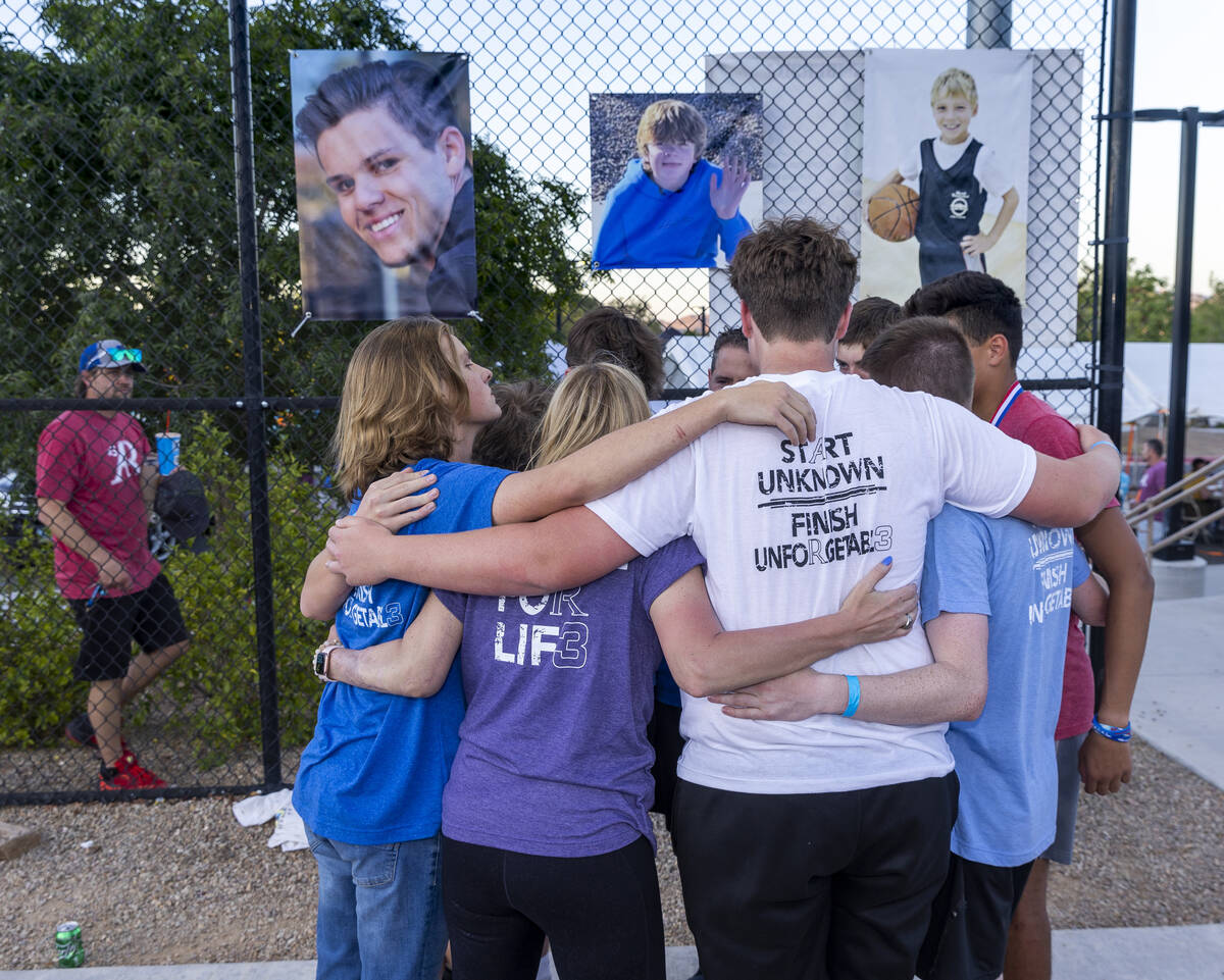 Deedra and Troy Russell have a group hug with their son’s friends during a celebration o ...
