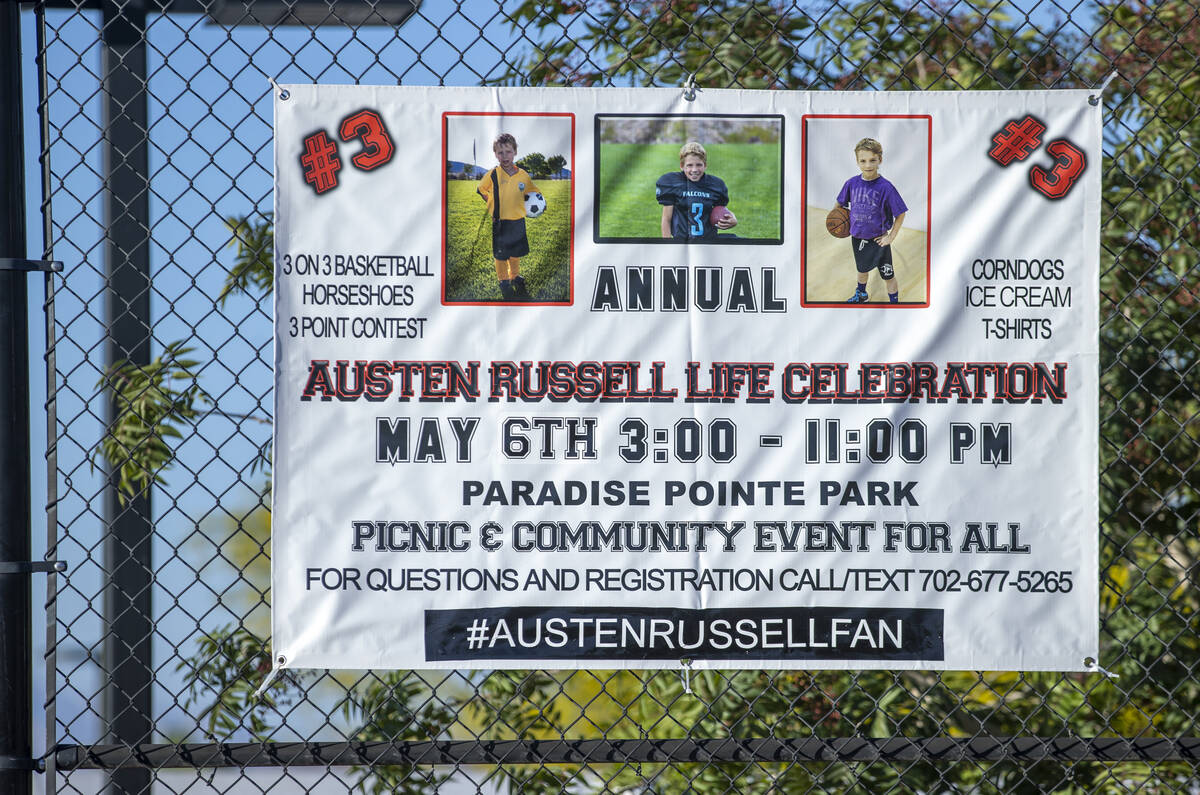 A sign hangs on the basketball court as part of a celebration of life for Austen Russell, 9, wh ...