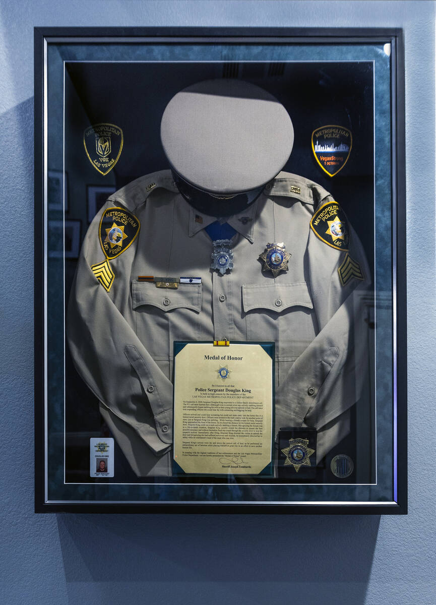 A framed uniform and medal of honor certificate on the wall at the home of Las Vegas police Sgt ...