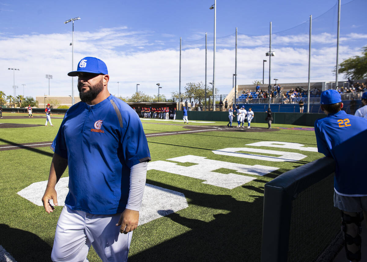The Bishop Gorman baseball head coach Gino DiMaria, left, walks off the field during a playoff ...