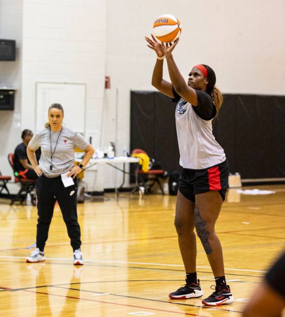 Las Vegas Aces center Kalani Brown prepares to throw the bal]kk as head coach Becky Hammon look ...