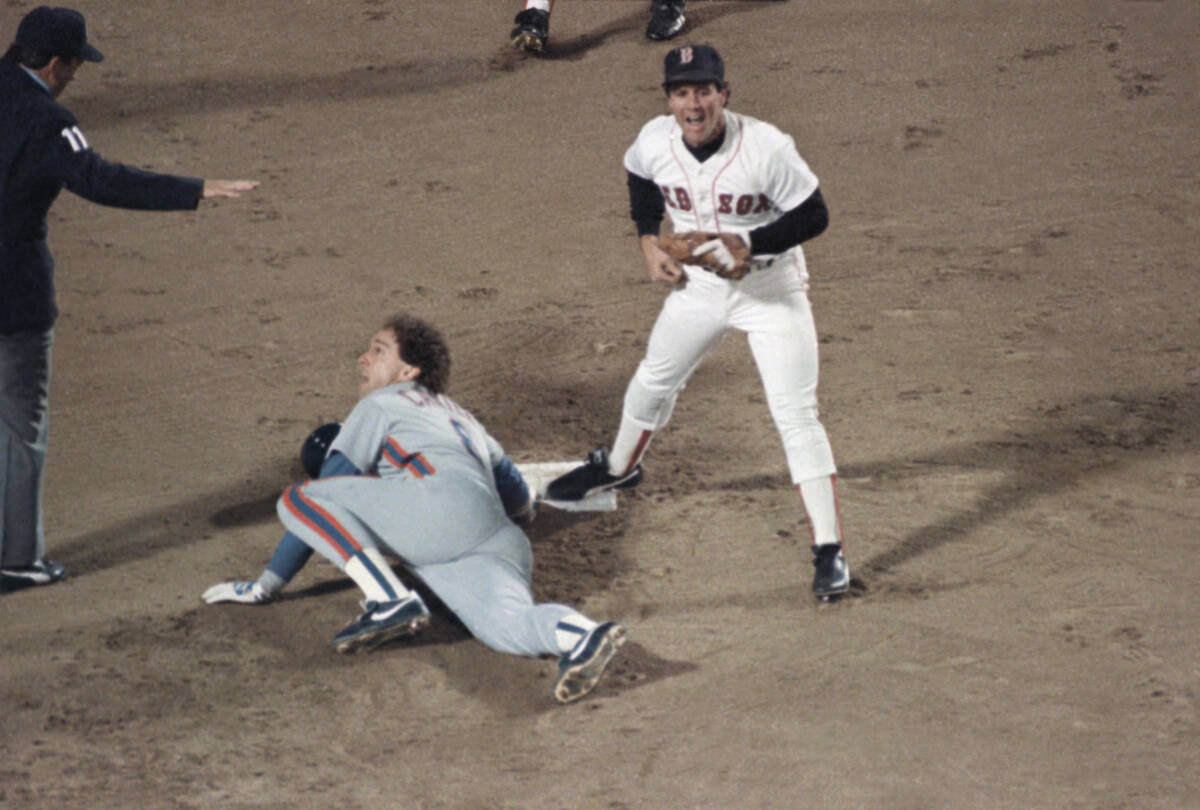 New York Mets Gary Carter, on ground, and Boston Red Sox Marty Barrett react as umpire Ed Monta ...