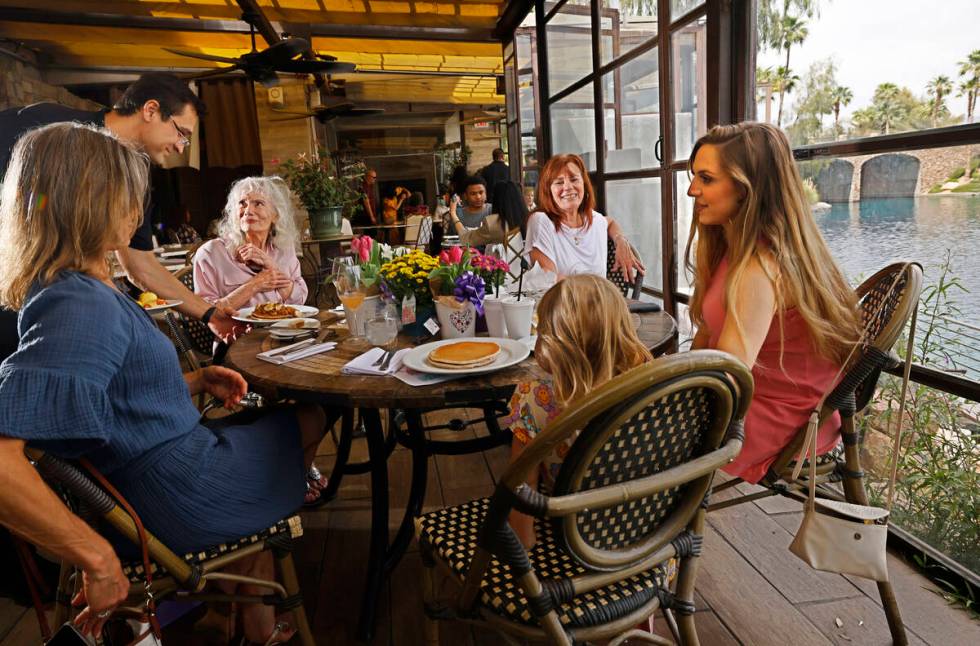 Waiter Angel Crisp serves a dish to Joanne Young, 91, of Las Vegas, second from left, as she ce ...