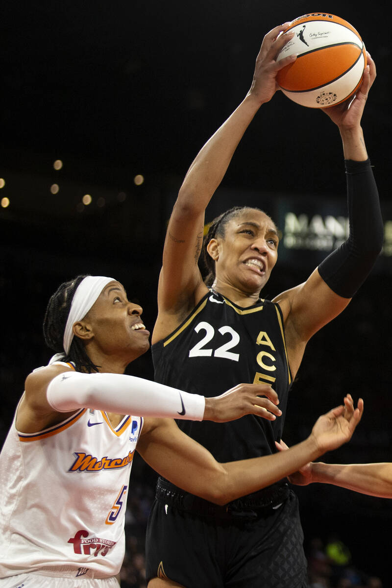 Las Vegas Aces forward A'ja Wilson (22) gains control of the ball as Phoenix Mercury guard Shey ...