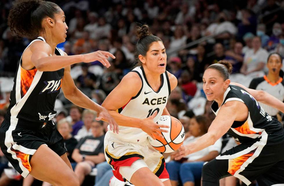 Las Vegas Aces' Kelsey Plum (10) drives to the basket between Phoenix Mercury's Skyler Diggins- ...