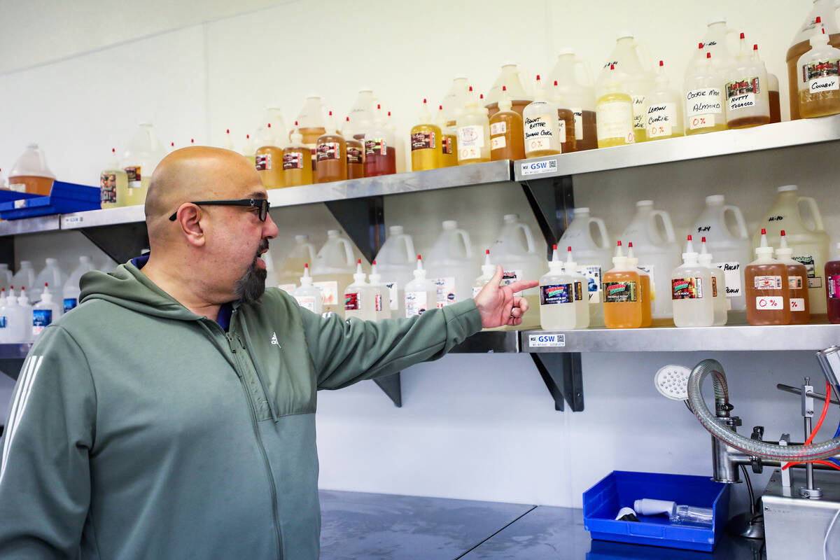 Owner Alex Mazzola points out ingredients used to manufacture e-liquids for vaping at Mob Liqui ...