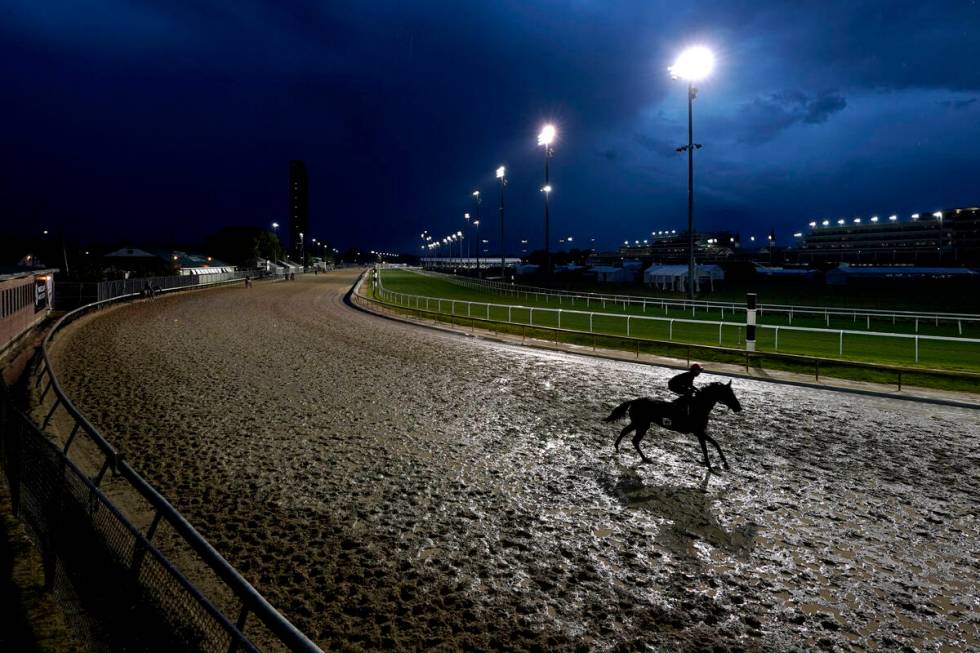 Horses work out in the rain at Churchill Downs Tuesday, May 3, 2022, in Louisville, Ky. The 148 ...