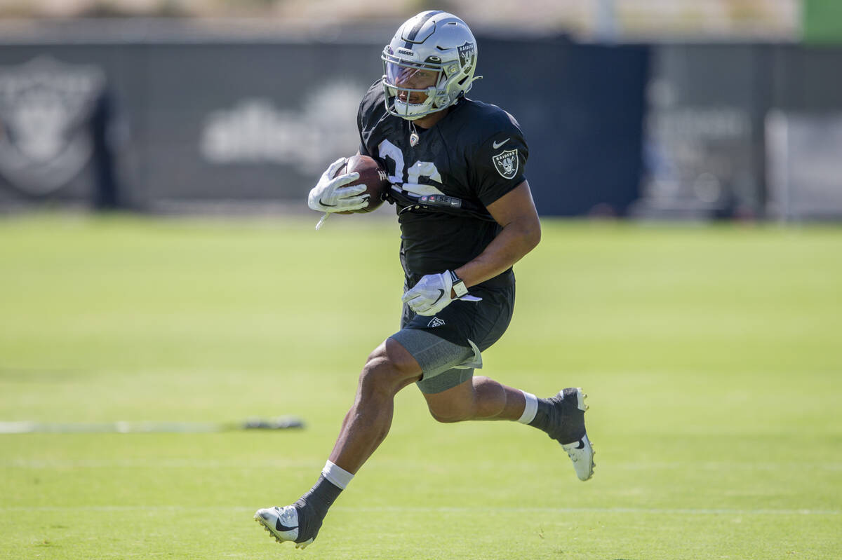 Raiders running back Trey Ragas (36) runs with the football during team practice at the Raiders ...