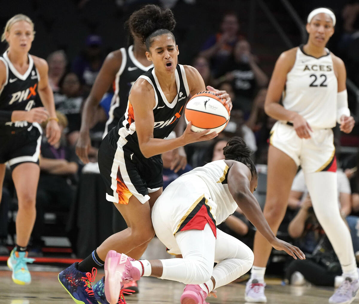 Phoenix Mercury's Skyer Diggins-Smith (4) gets bumped at the knees by Las Vegas Aces' Chelsea G ...