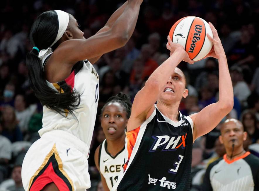 Phoenix Mercury's Diana Taurasi (3) shoots as Las Vegas Aces' Jackie Young (0) defends during t ...
