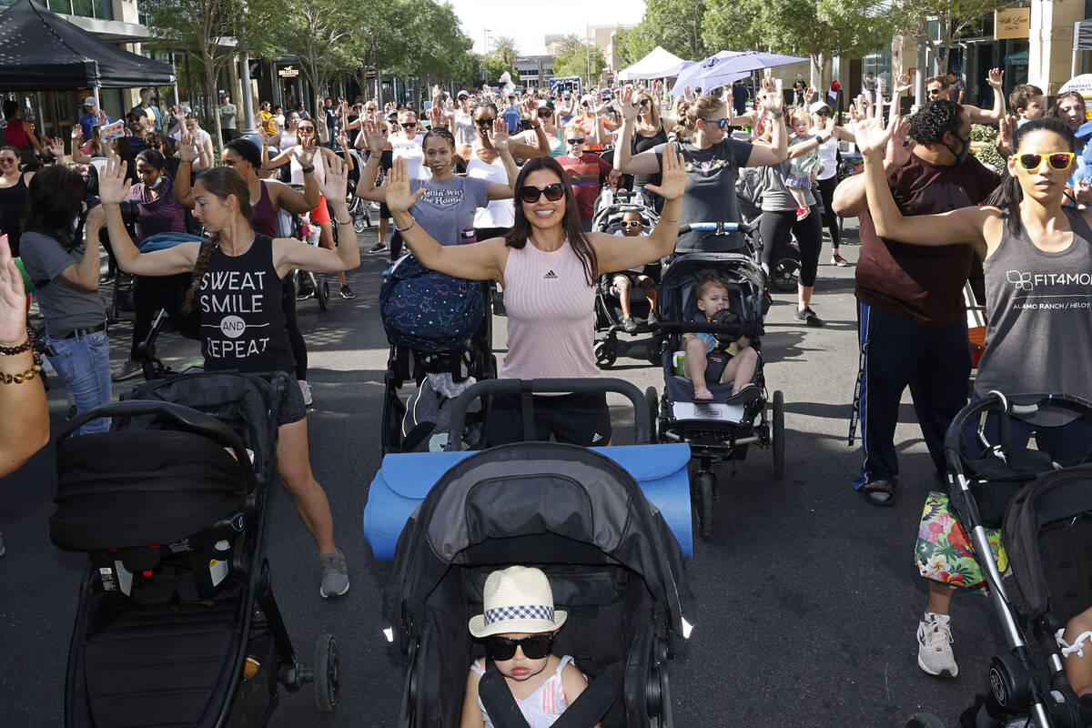 Yoisy Rivera, center, works out with her daughter Lucy, 20 month-old, foreground, during the ni ...