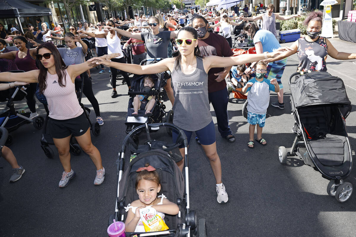 Ciara Chen, center, of Las Vegas works out with her daughter Lilliana, 2, foreground, during th ...