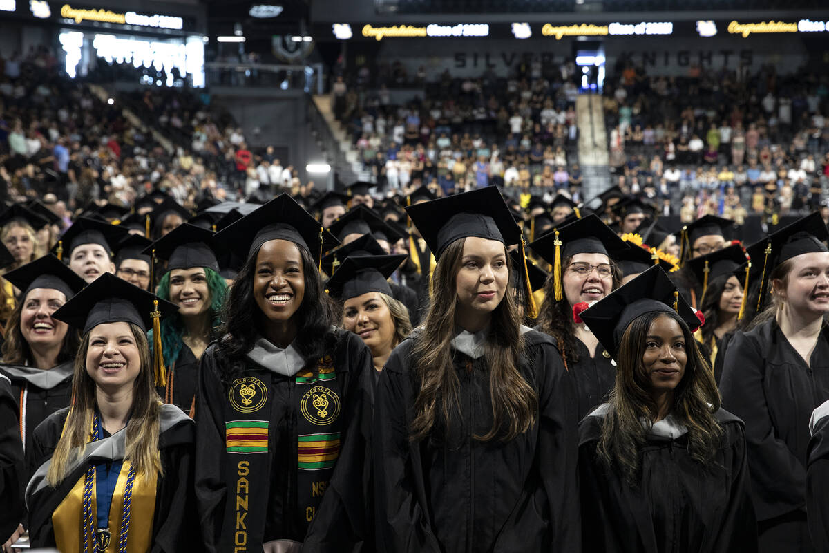 Graduates react to speakers during commencement for Nevada State College at Dollar Loan Center ...