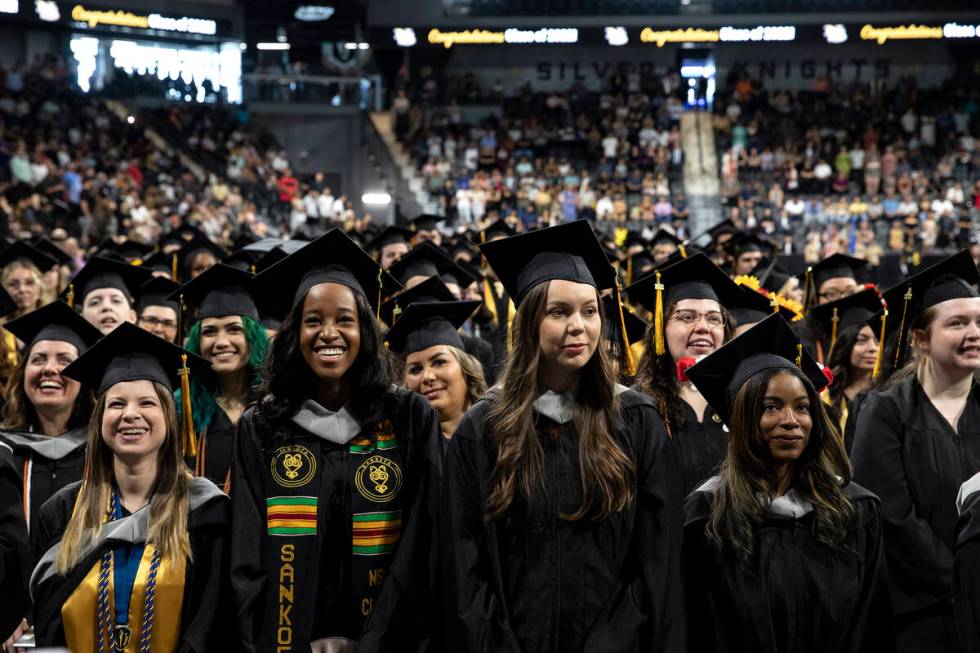 Graduates react to speakers during commencement for Nevada State College at Dollar Loan Center ...