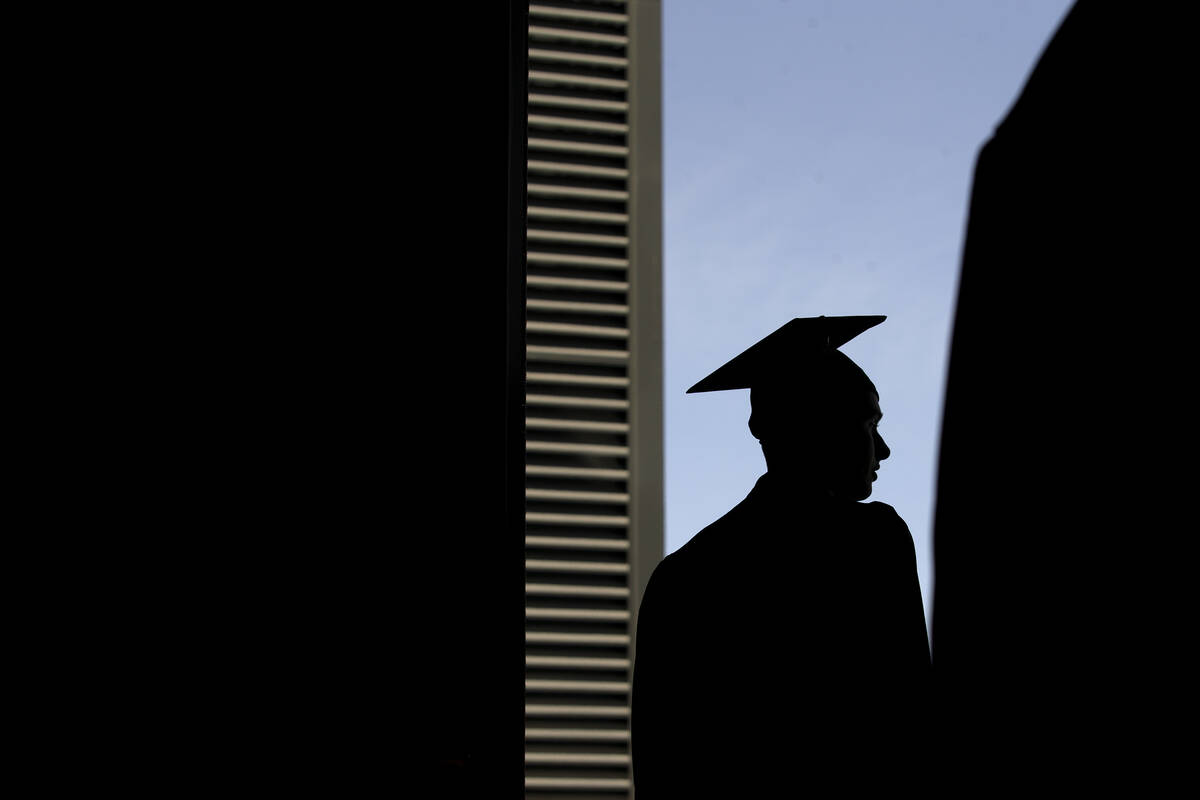 A graduate exits after commencement for Nevada State College at Dollar Loan Center Arena on Sat ...