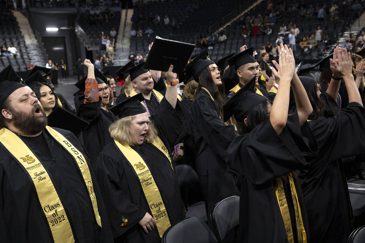 Graduates cheer as their degrees are confirmed during commencement for Nevada State College at ...