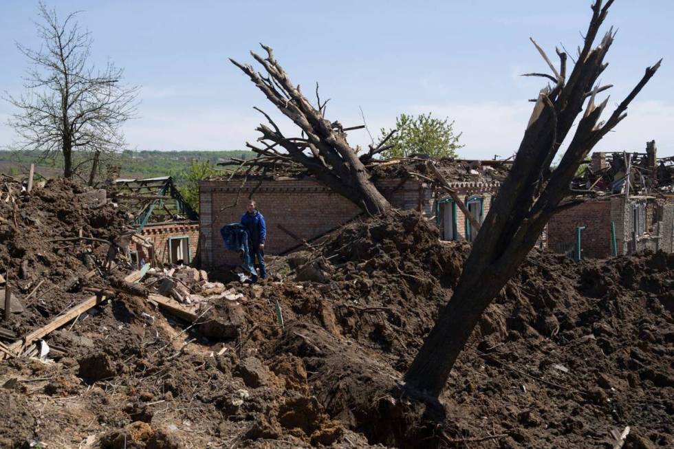 People stand in destroyed residential area after Russian airstrike in Bakhmut, Donetsk region, ...