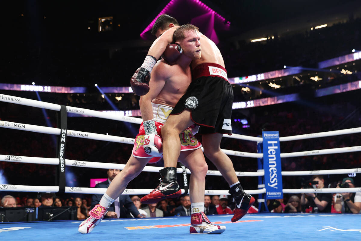 Saul “Canelo” Alvarez, left, battles Dmitry Bivol in the 11th round of the WBA su ...