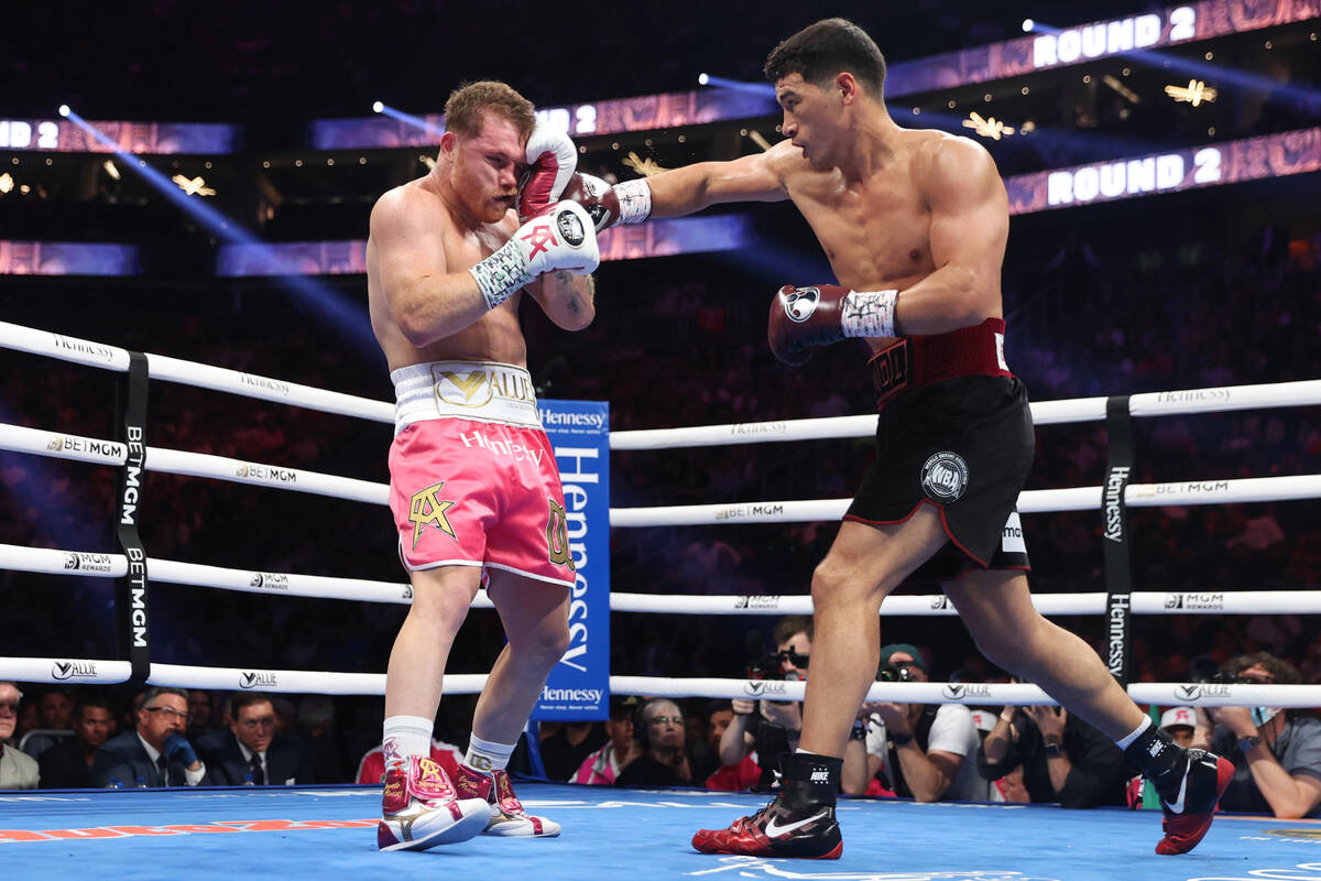 Dmitry Bivol, right, throws a punch against Saul “Canelo” Alvarez in the second round of th ...
