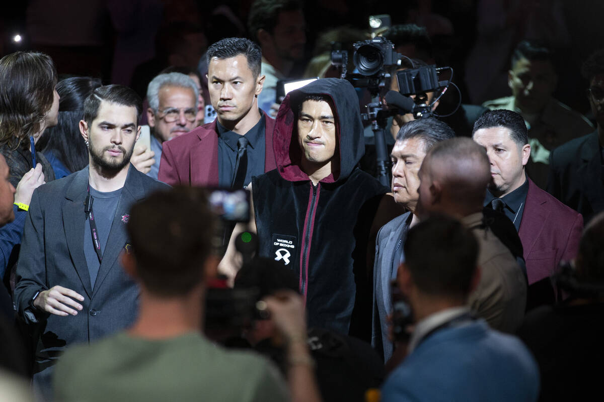 Dmitry Bivol makes his way to the ring for the WBA super light heavyweight title bout against S ...