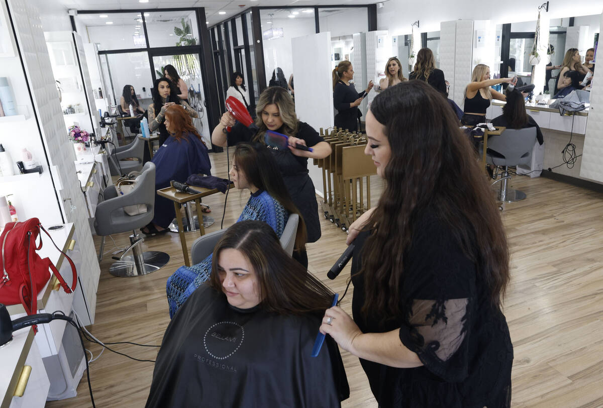 Capelli Salon hairdresser Jessica Bonsignore, right, dries the hair of Tania MacDavid, a surviv ...