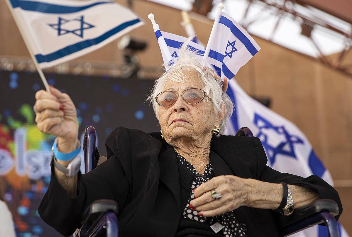 Holocaust survivor Lucy Jacobs, 94, waves an Israeli flag during a celebration of Israel&#x2019 ...