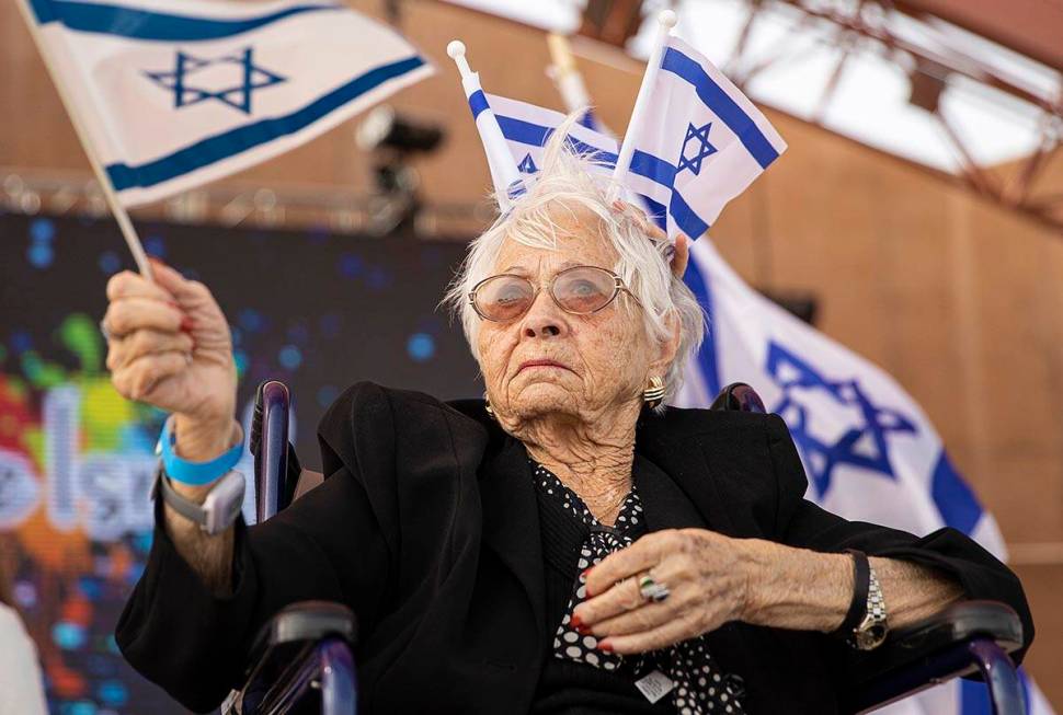 Holocaust survivor Lucy Jacobs, 94, waves an Israeli flag during a celebration of Israel’s in ...