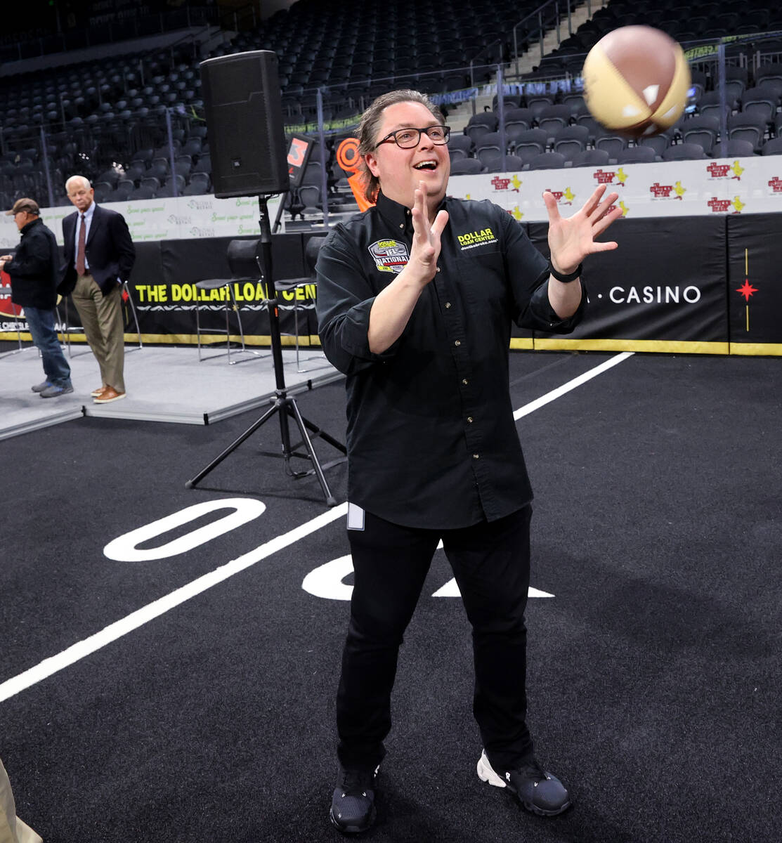 Dollar Loan Center Founder and CEO Chuck Brennan plays with an IFL football during an announcem ...